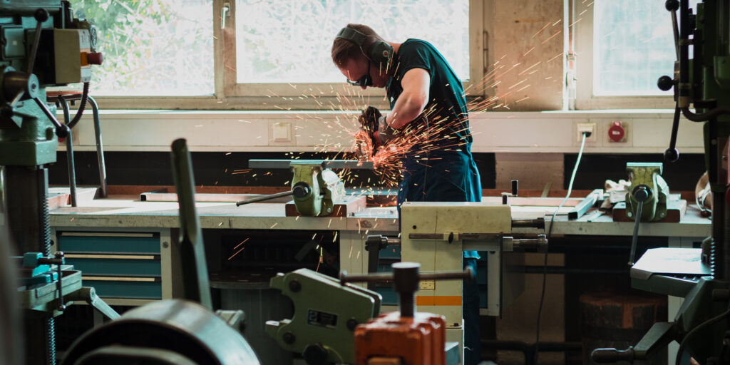 man grinding metal