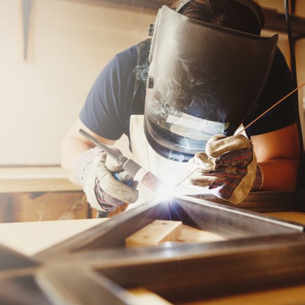 person working on both a square and 45 degree of welding