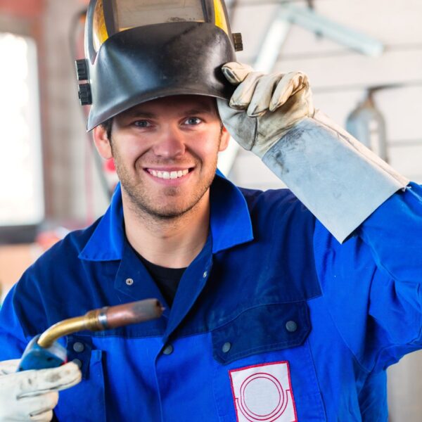smiling welder wearing gloves